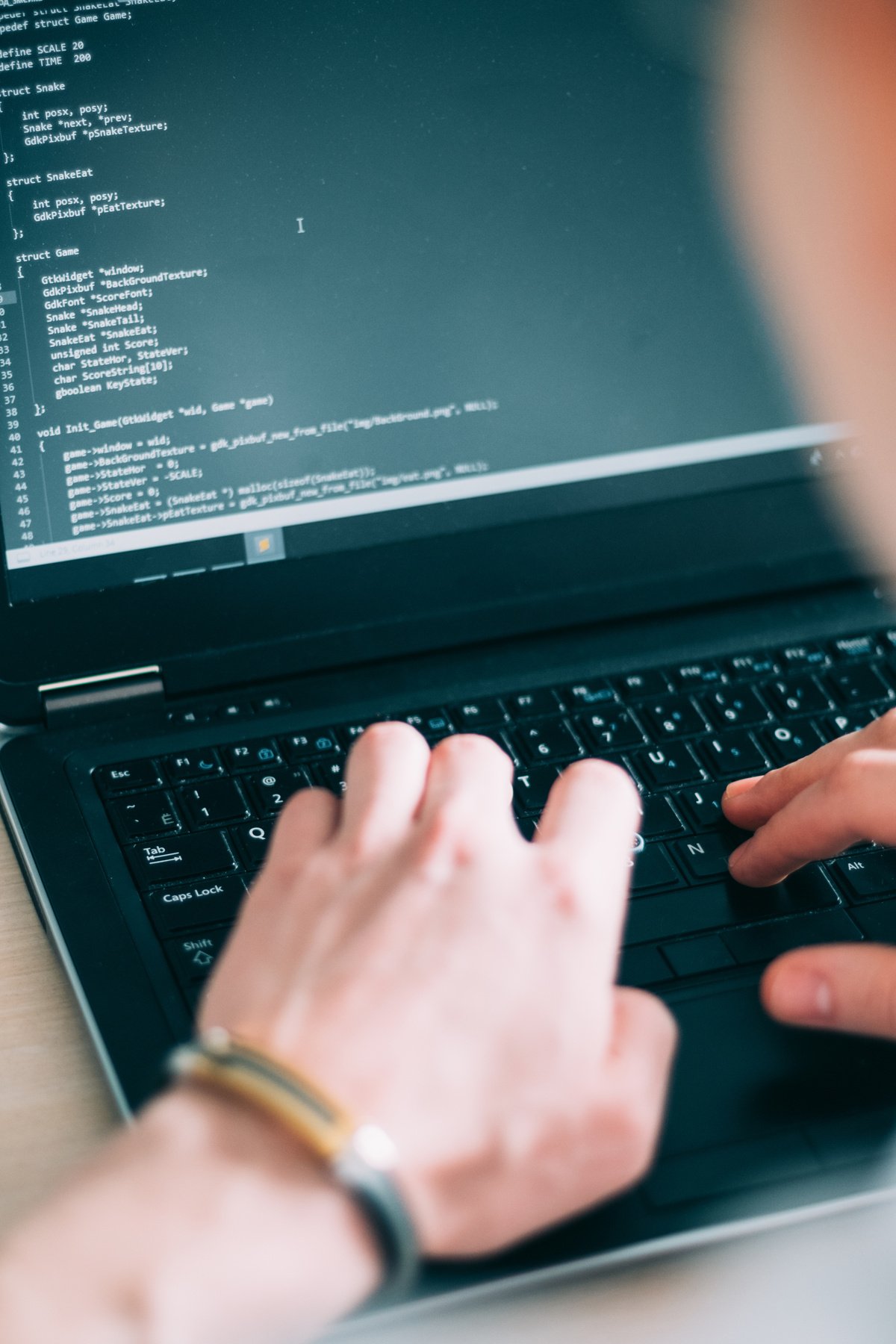 a person typing on a laptop keyboard